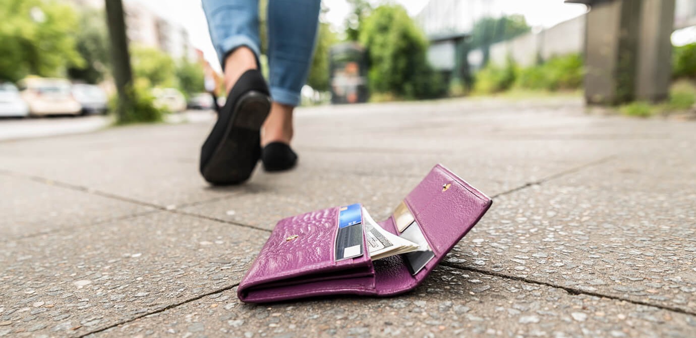 A person lost their wallet on the sidewalk.